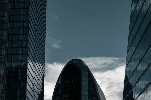 London Gherkin framed by nearby buildings