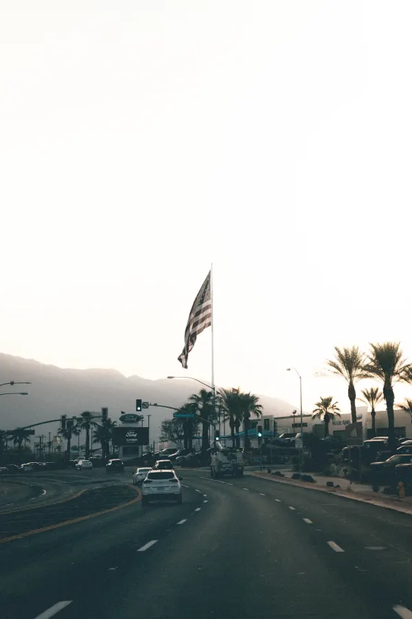 American flag over a desert road